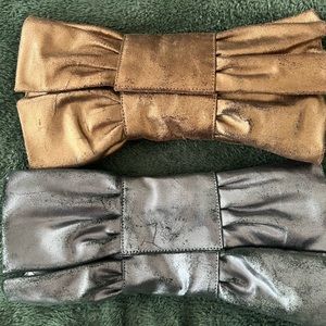 Two Leather BOW Clutches. Black metallic clutch, and a copper metallic clutch.